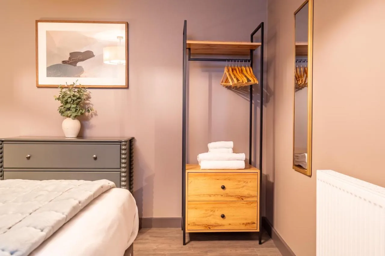 a bedroom with a bed and a dresser and a mirror at The Falcon in York